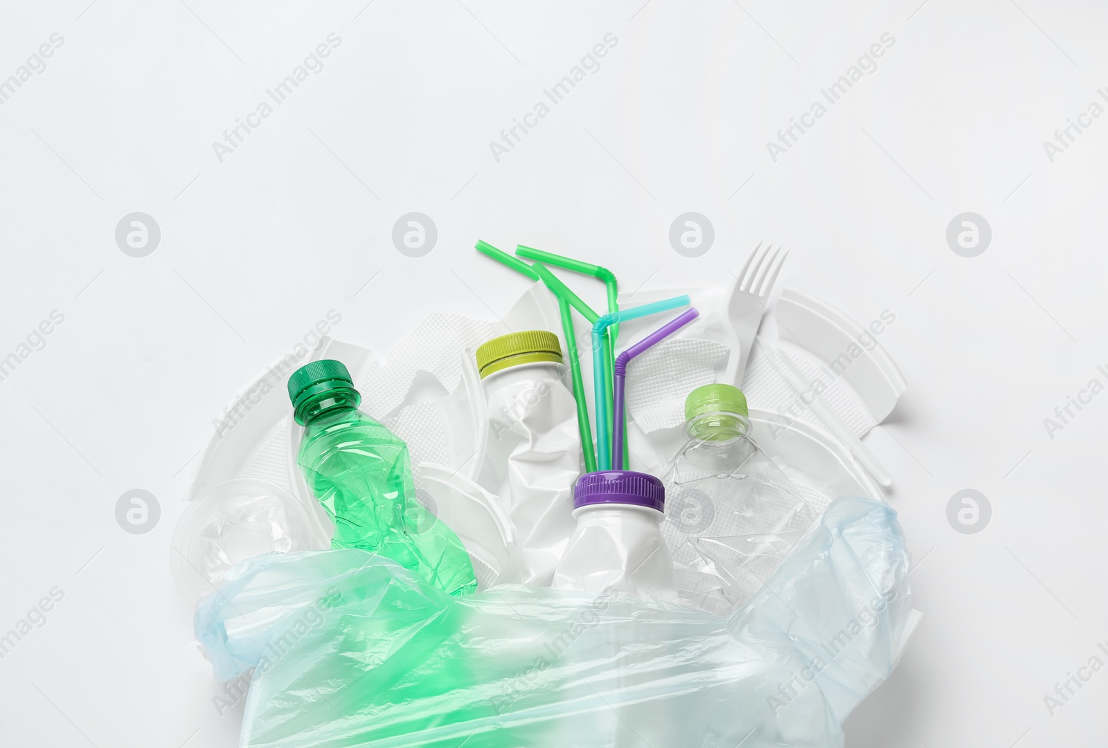 Photo of Pile of different plastic items on white background, flat lay