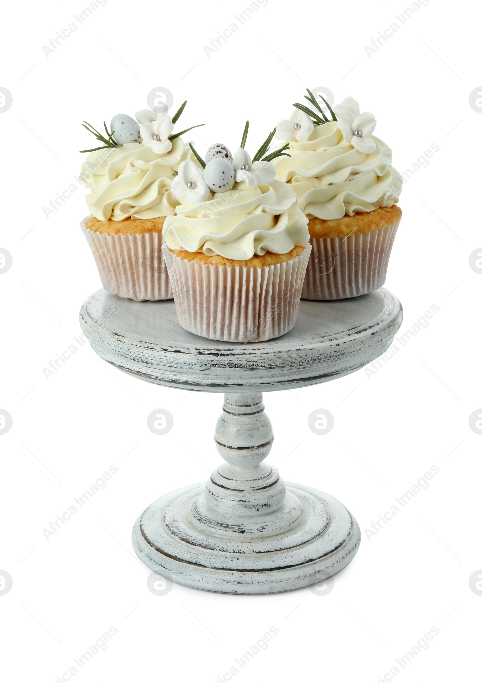 Photo of Tasty Easter cupcakes with vanilla cream isolated on white