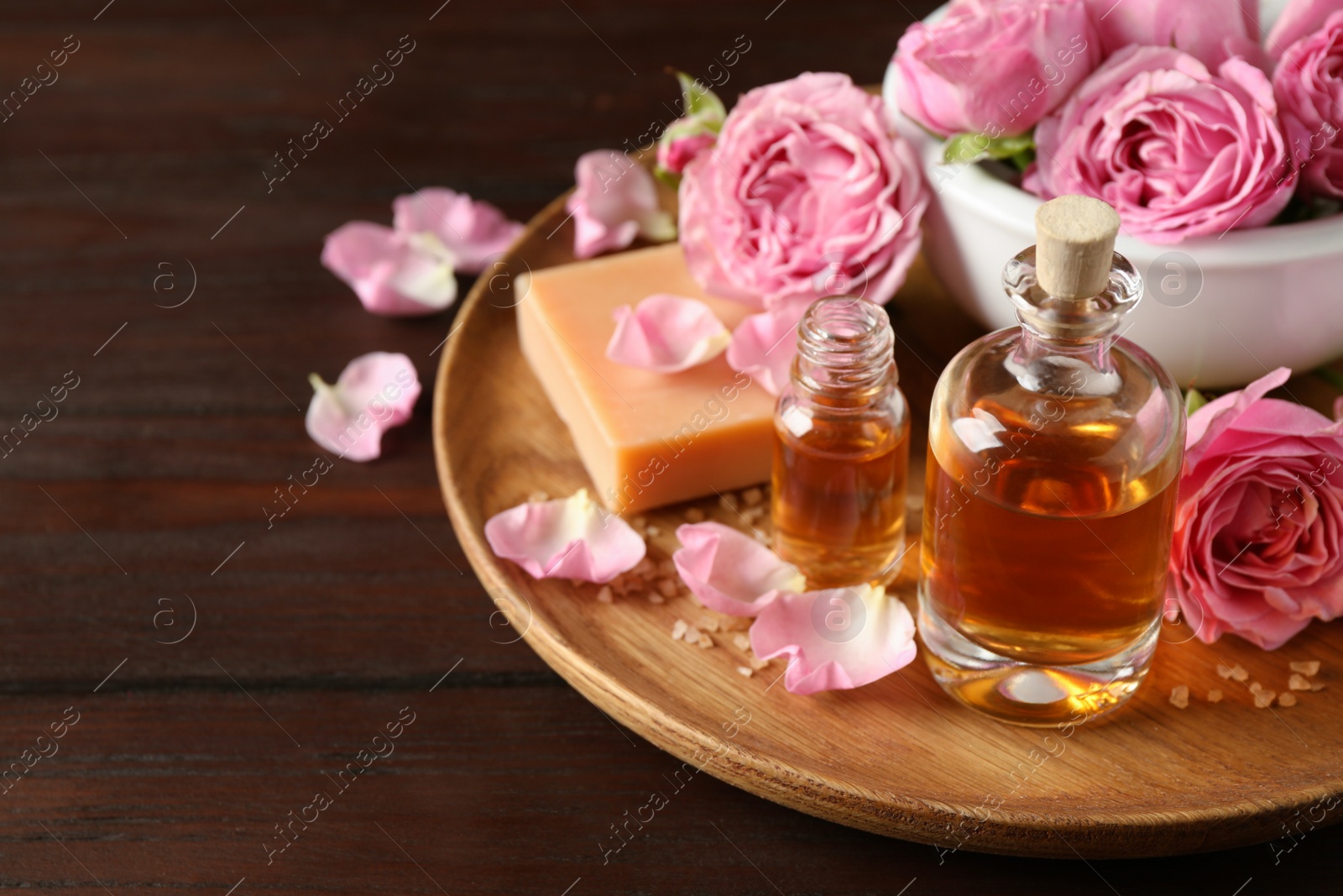 Photo of Composition with aroma oil on wooden table, space for text