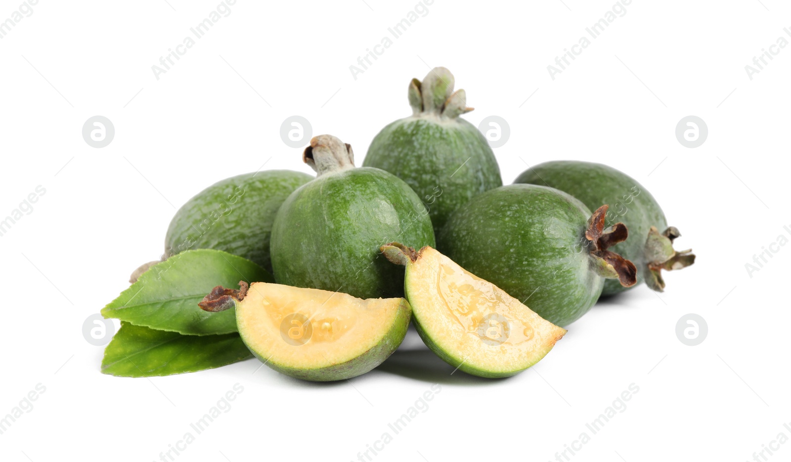 Photo of Cut and whole feijoas with leaves on white background