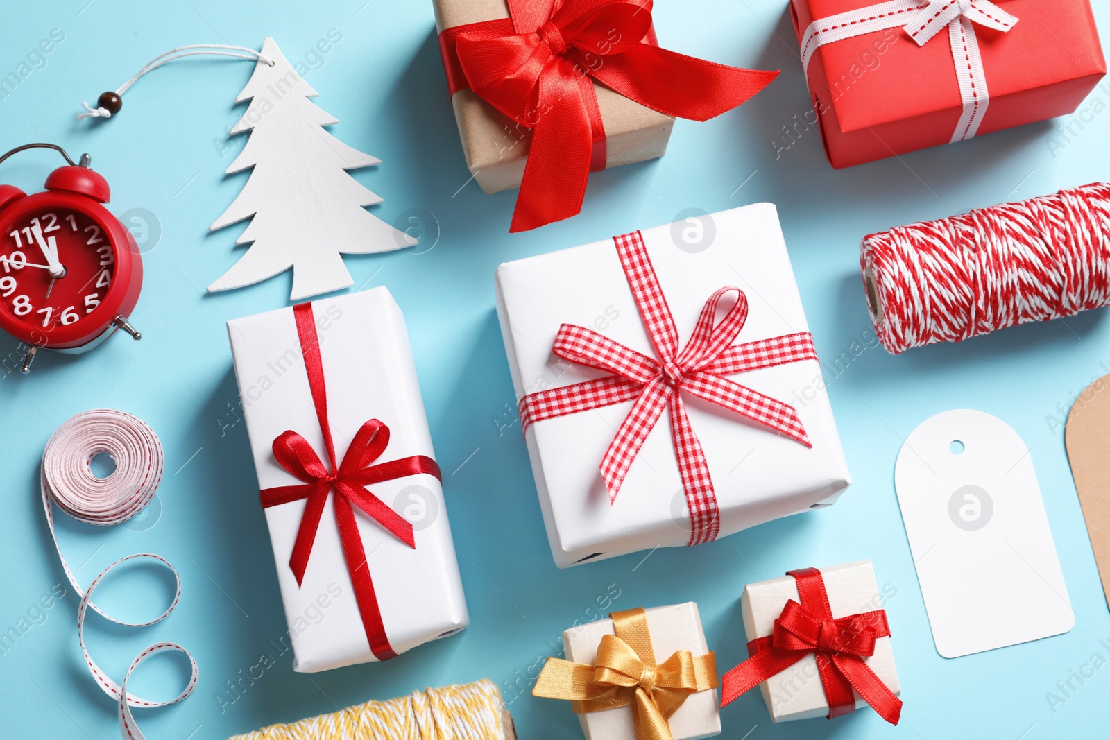 Photo of Flat lay composition with gift boxes on color background, top view