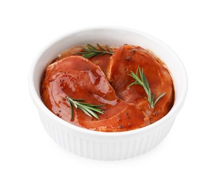Photo of Raw marinated meat and rosemary in bowl isolated on white