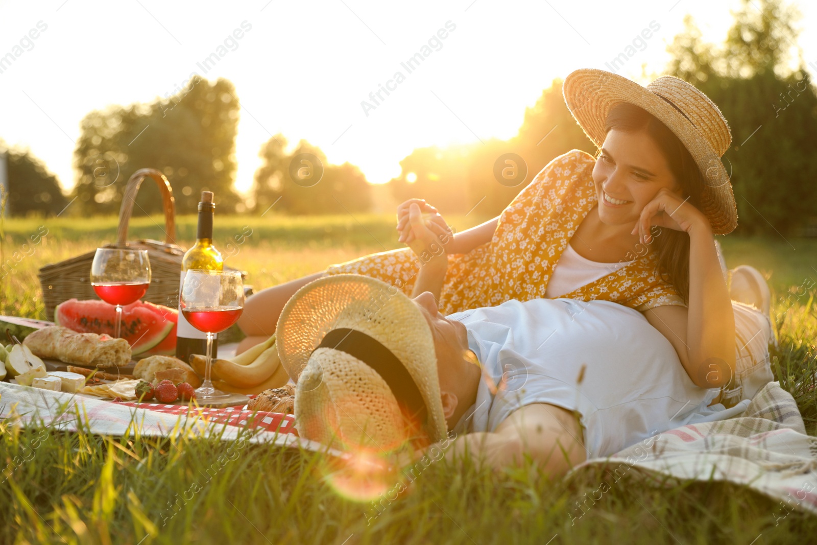 Photo of Happy couple having picnic in park on sunny day