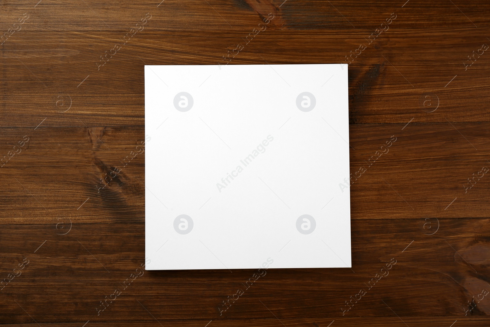Photo of Blank paper sheet on wooden table, top view. Brochure design