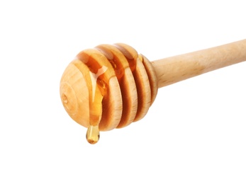 Honey dripping from dipper on white background