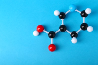 Molecule of vitamin B3 on light blue background, top view with space for text. Chemical model