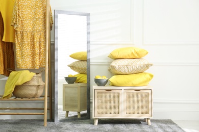 Photo of Stylish dressing room with big mirror. Interior design in grey and yellow colors