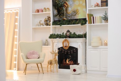 Living room with fireplace and Christmas decorations. Festive interior design