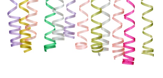 Many colorful serpentine streamers on white background