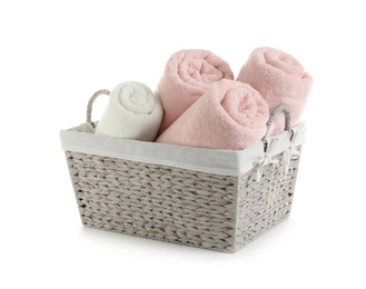 Rolled soft towels in basket on white background