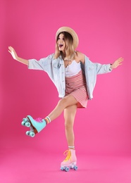 Young woman with retro roller skates on color background