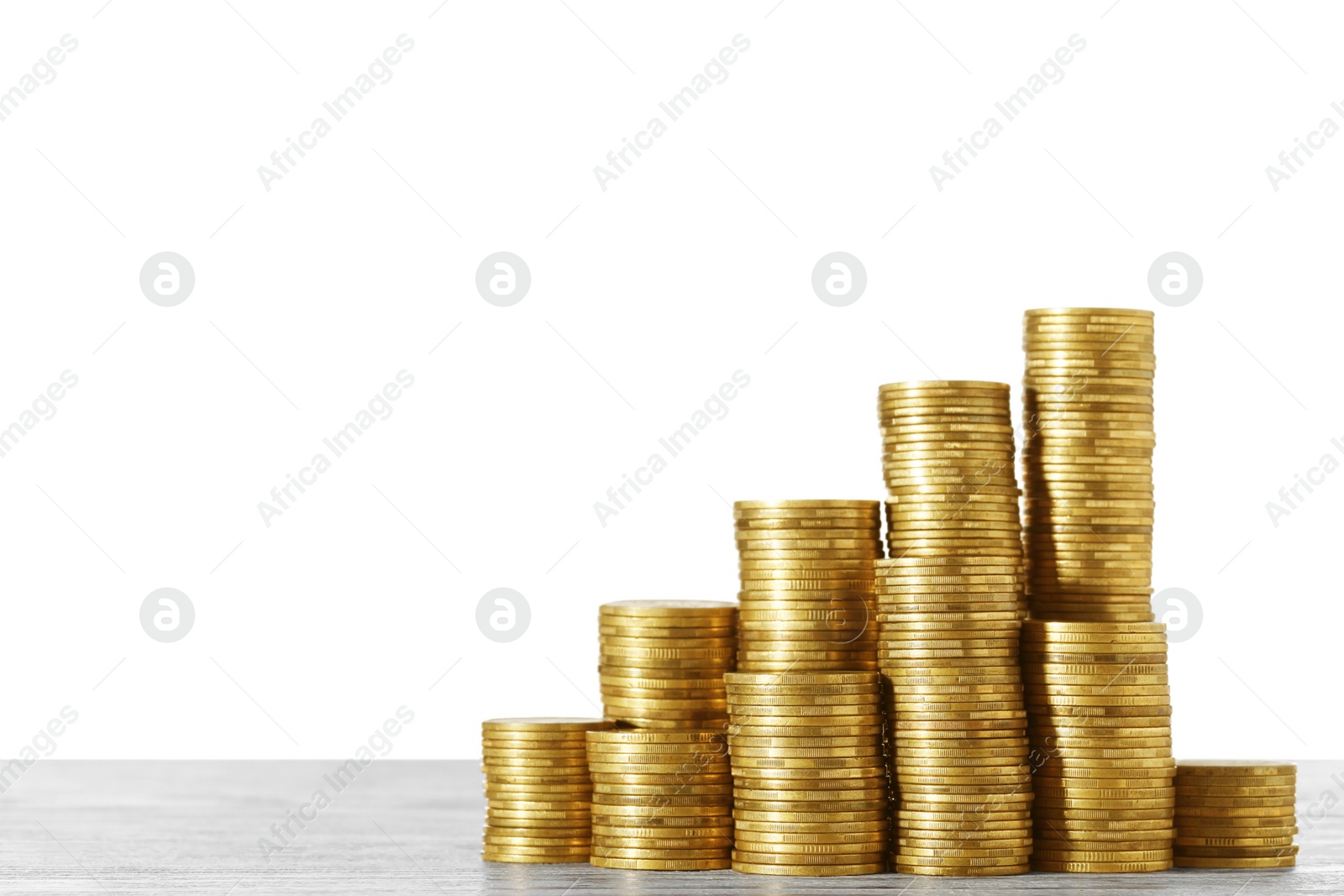 Photo of Stack of coins on wooden table. Space for text