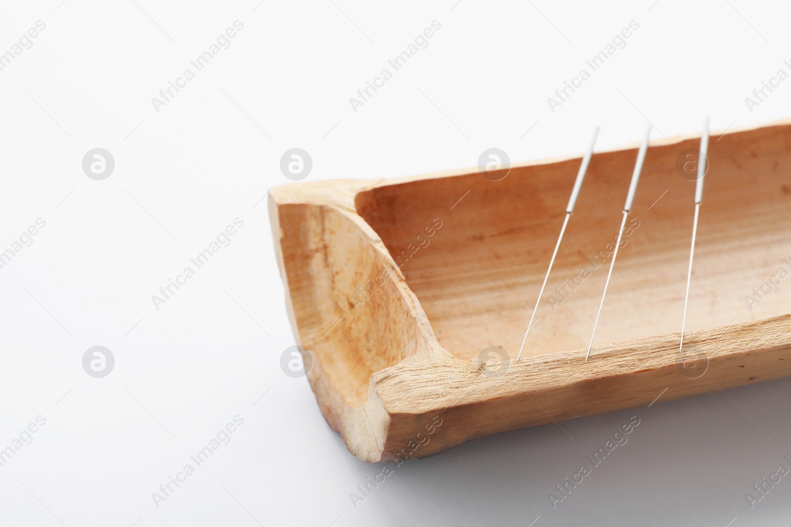Photo of Bamboo stick with needles for acupuncture on white background