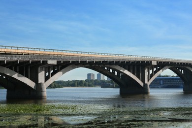 Photo of Beautiful view of arch bridge over river on sunny day
