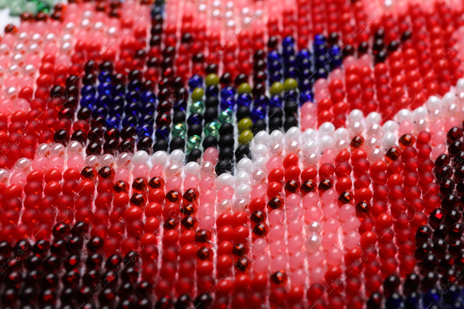 Photo of Beautiful floral bead embroidery as background, closeup