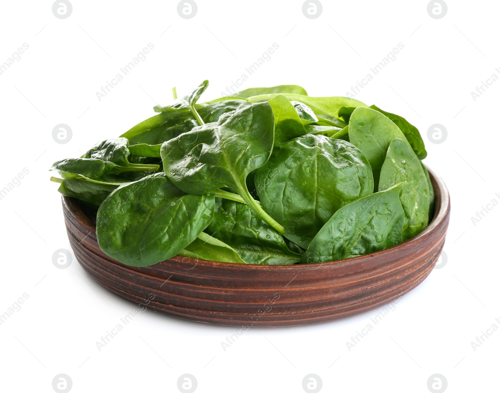 Photo of Fresh green healthy baby spinach leaves in wooden plate isolated on white