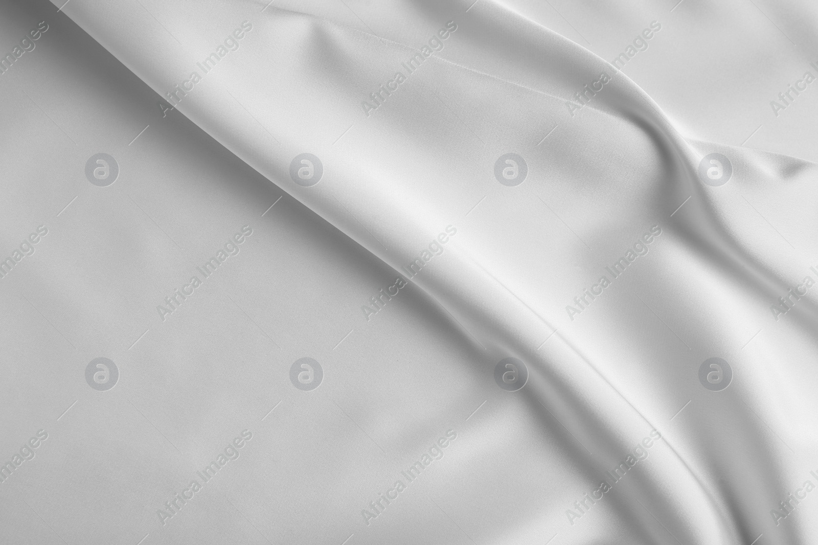 Photo of Texture of white silk ripple fabric as background, top view