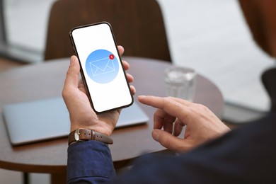 Image of Man checking new message on mobile phone indoors, closeup