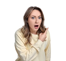 Portrait of surprised woman pointing at something on white background