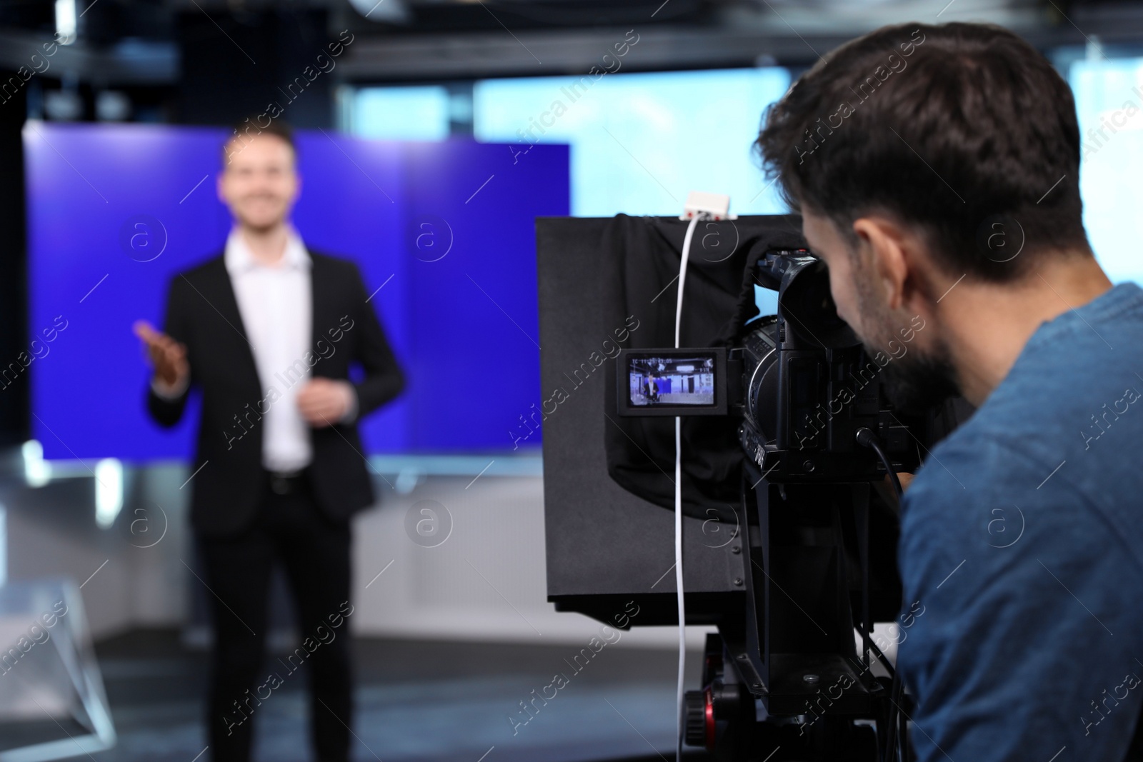 Photo of Professional video camera operator working in studio, closeup