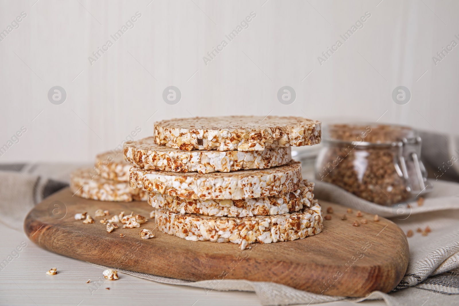 Photo of Stack of fresh crunchy rice cakes on white wooden table, closeup