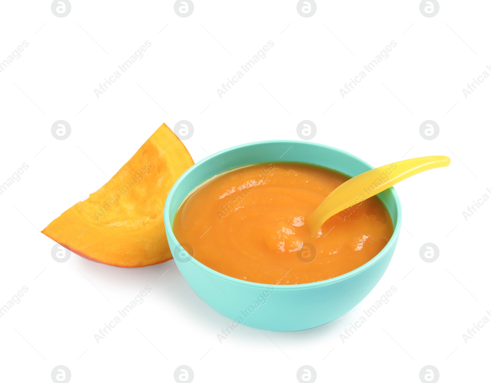 Photo of Bowl of healthy baby food and pumpkin slice on white background