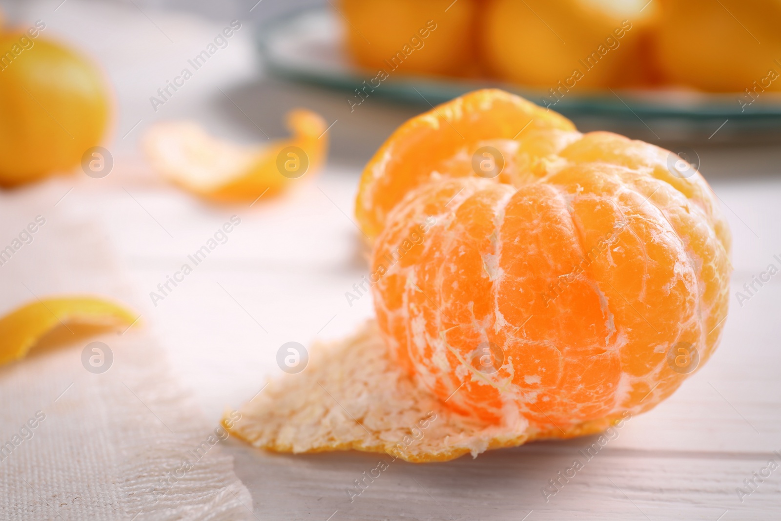 Photo of Fresh tangerine on white wooden table, closeup. Citrus fruit