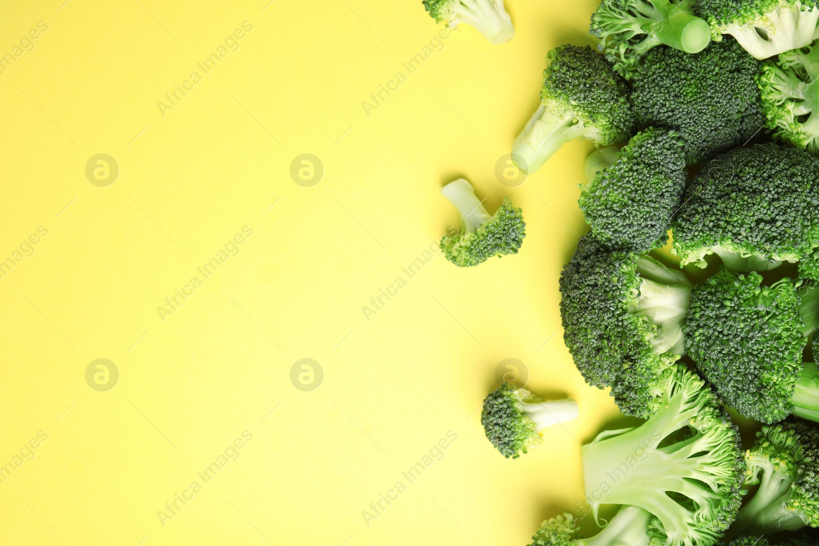 Photo of Flat lay composition with fresh green broccoli on color background. Space for text