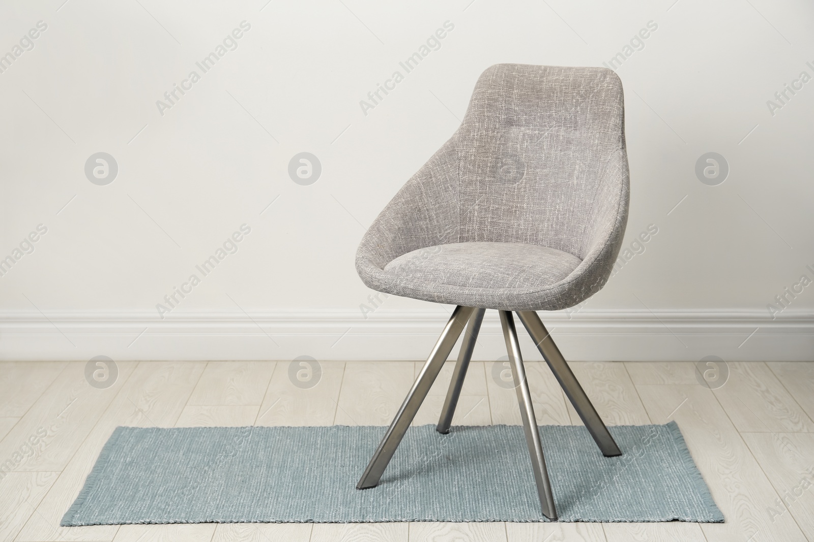 Photo of Stylish beige chair near white wall indoors. Space for text