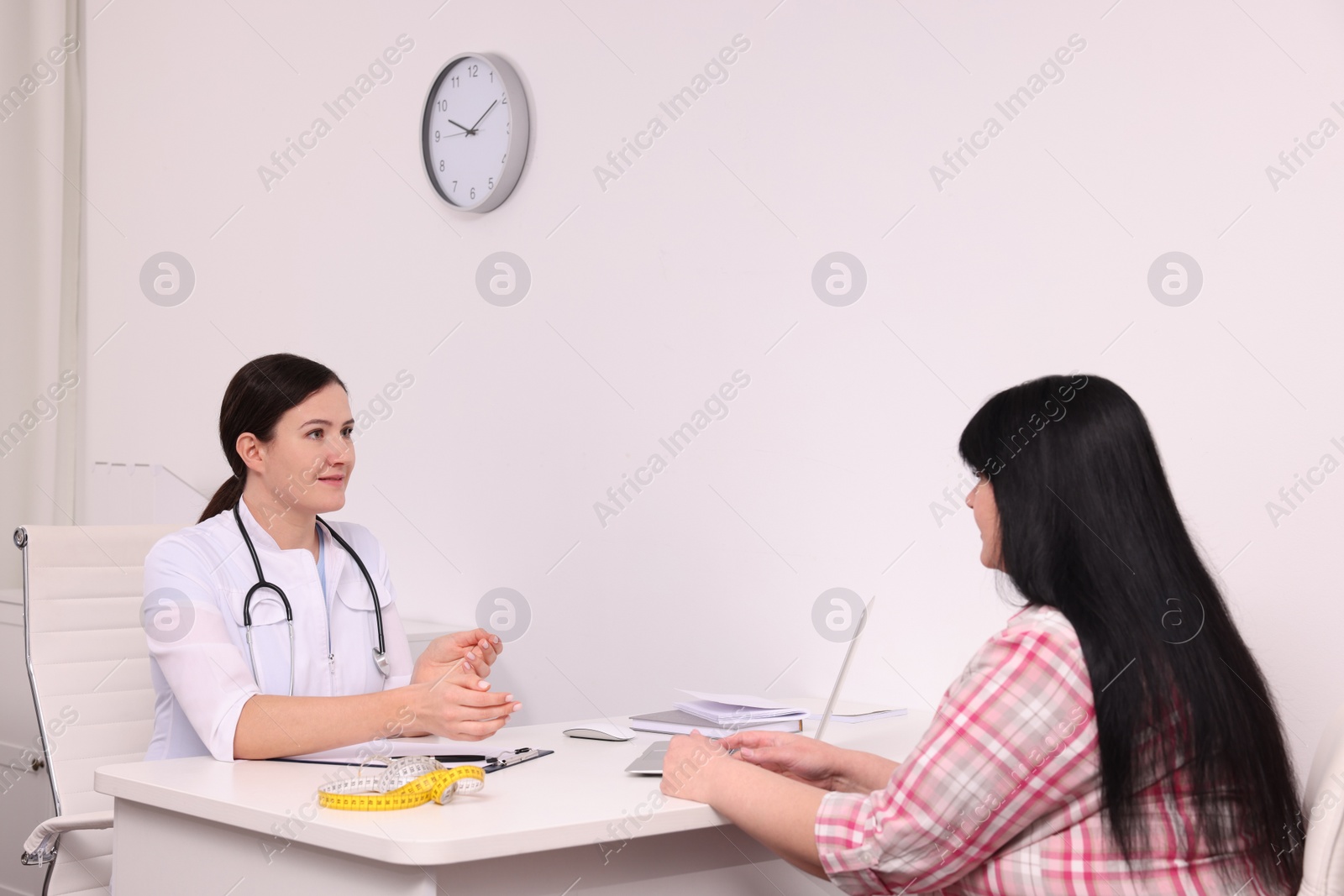 Photo of Overweight woman consulting with nutritionist in clinic