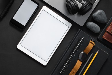 Photo of Flat lay composition with modern tablet on black background. Space for text