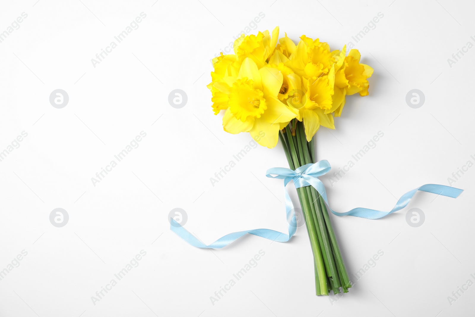 Photo of Bouquet of daffodils on white background, top view. Fresh spring flowers