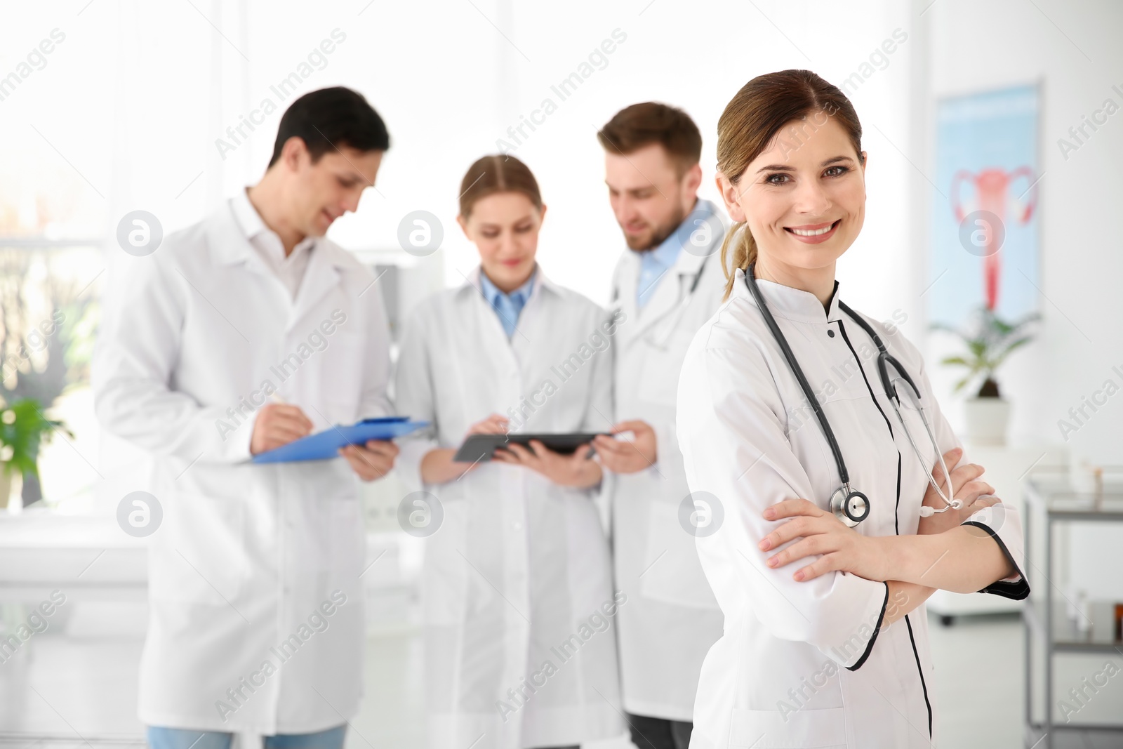 Photo of Smiling female doctor wearing uniform in modern hospital. Gynecology department