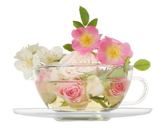 Aromatic herbal tea in glass cup with different flowers isolated on white