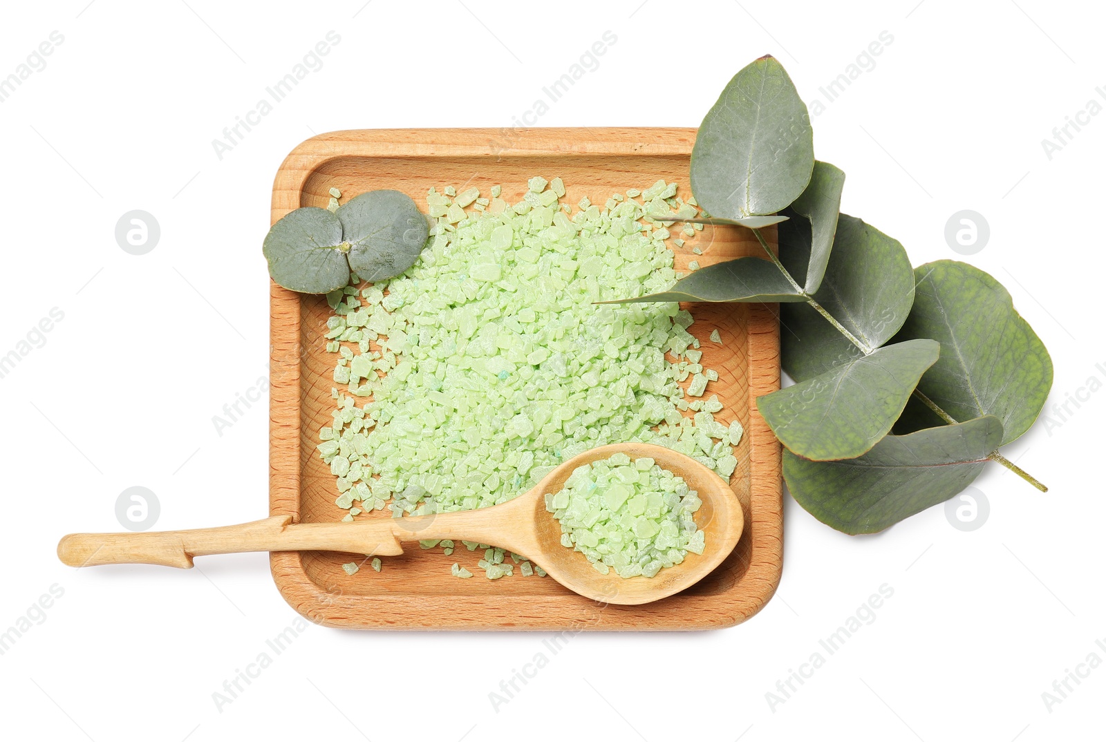 Photo of Green sea salt, spoon and eucalyptus leaves isolated on white, top view