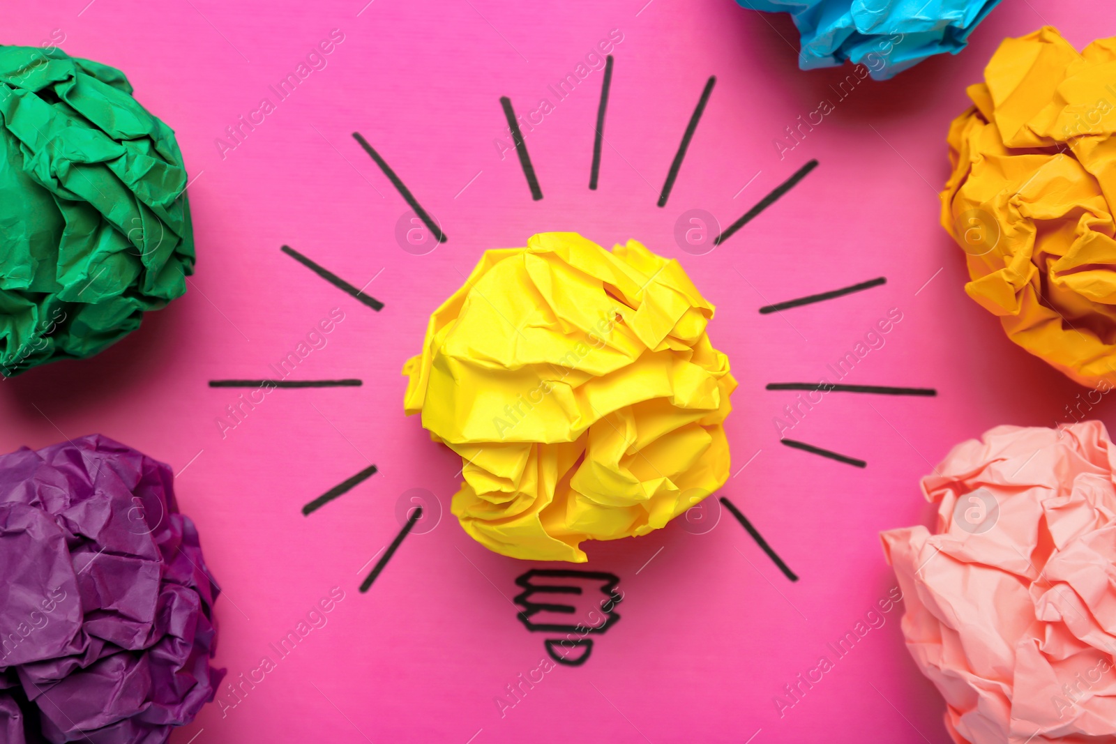 Photo of Creative flat lay composition with colorful paper balls on pink background. Idea concept