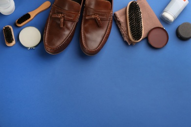 Flat lay composition with shoe care accessories and footwear on blue background. Space for text