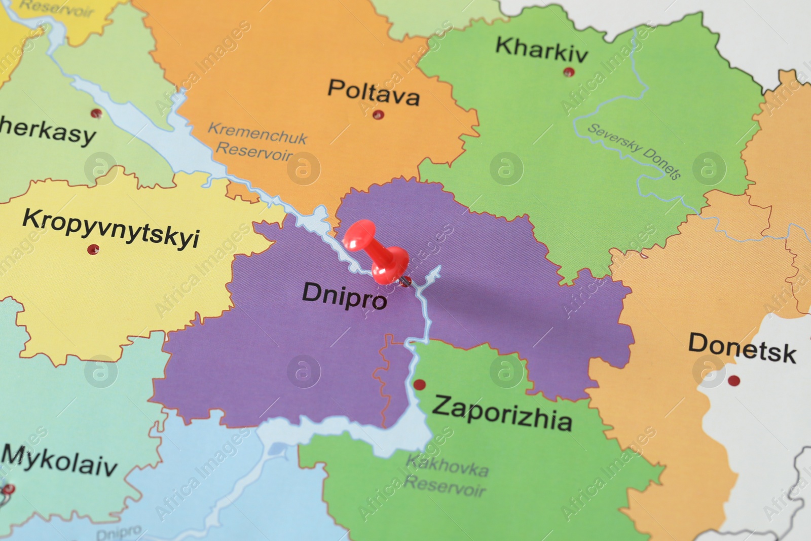 Photo of Map of Ukraine with red push pin placed on Dnipro, closeup