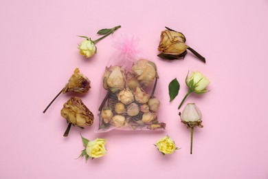 Scented sachet with dried roses on pink background, flat lay