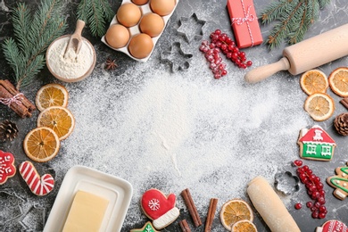 Photo of Flat lay composition with homemade Christmas cookies and ingredients on grey table, space for text