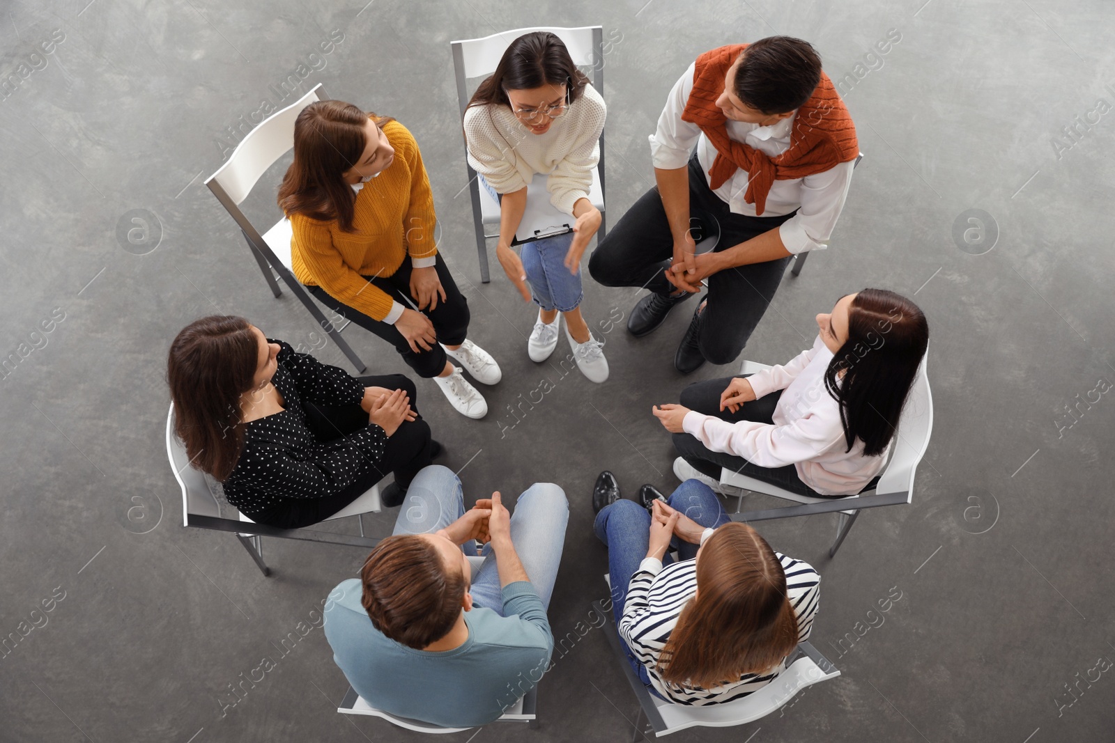 Photo of Psychotherapist working with patients in group therapy session, top view