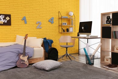 Stylish teenager's room interior with computer and bed