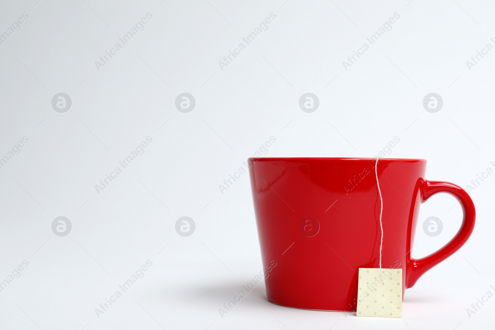 Photo of Cup of tasty tea on white background