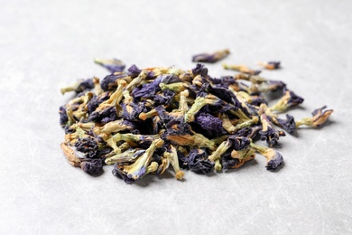Pile of dry organic blue Anchan on light table, closeup. Herbal tea