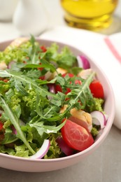 Photo of Delicious salad with chicken, arugula and tomatoes on table, closeup