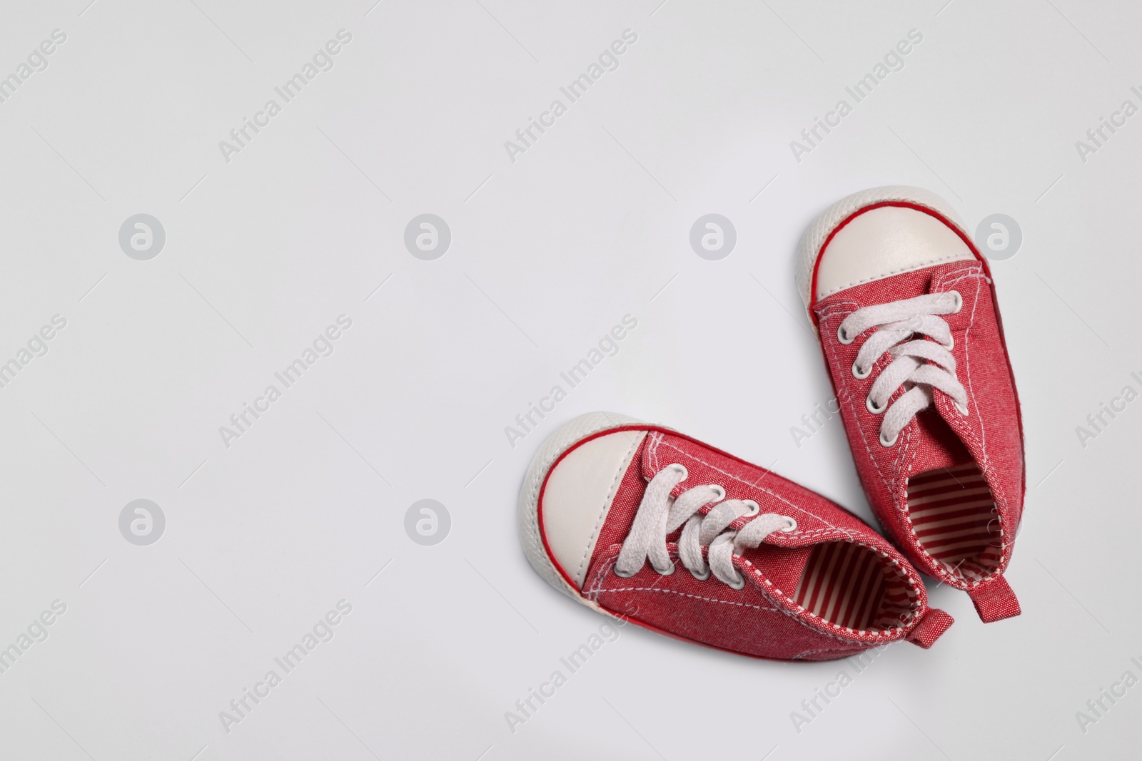 Photo of Cute baby shoes on white background, flat lay. Space for text