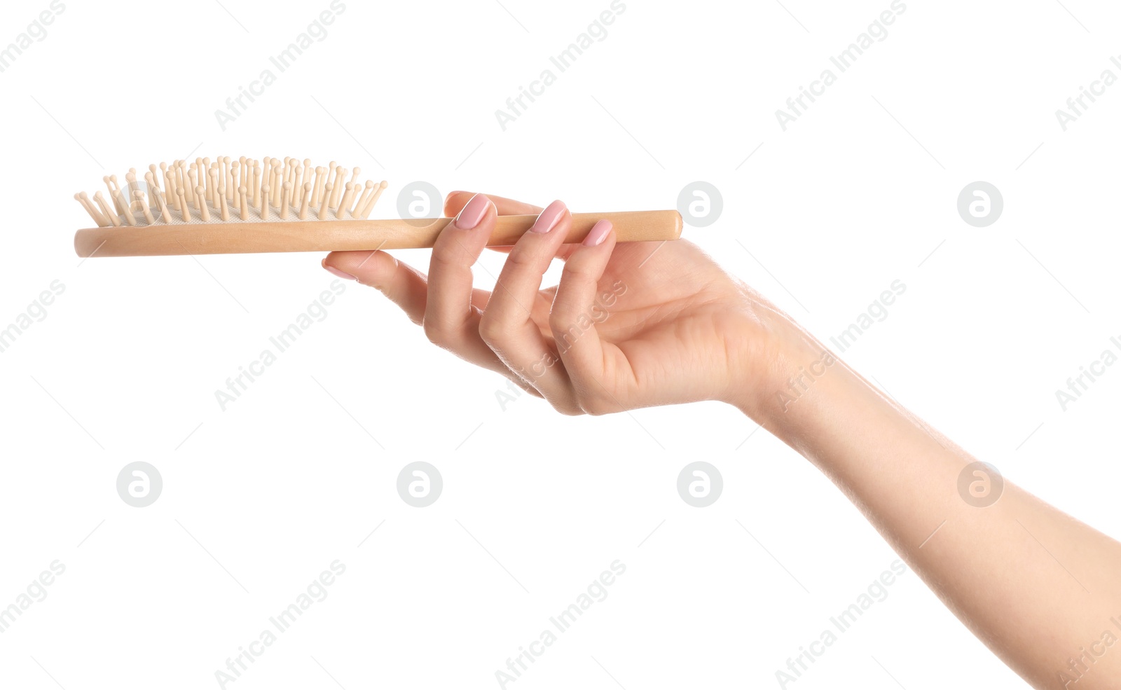 Photo of Woman holding wooden hair brush against white background, closeup