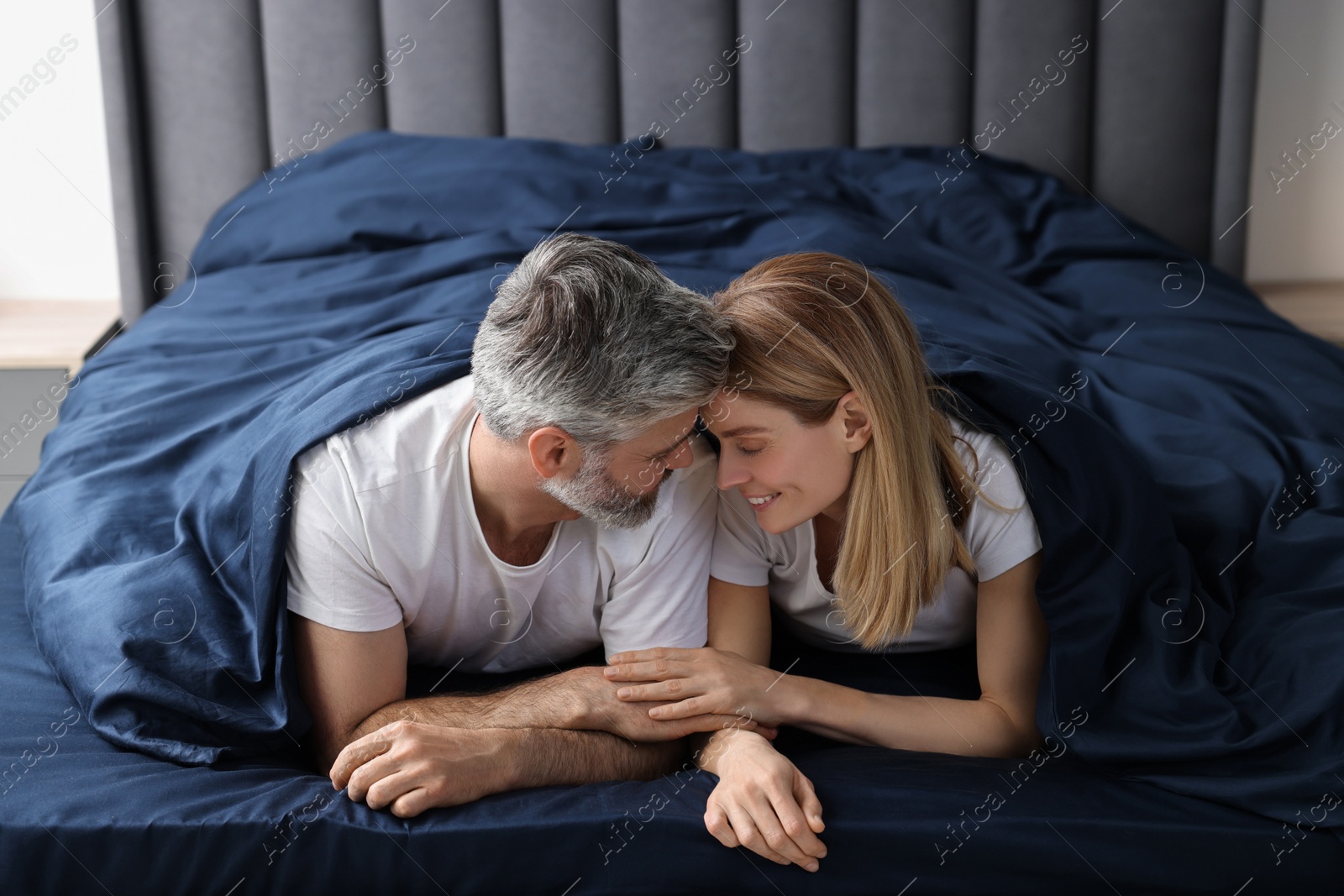 Photo of Lovely mature couple in bed at home