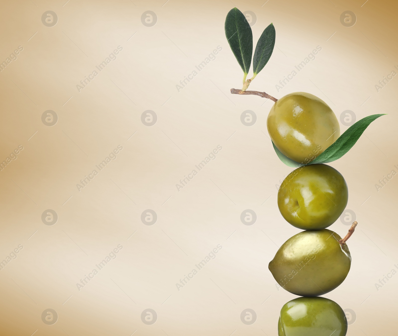 Image of Stack of whole green olives with leaves on pastel gold gradient background, space for text