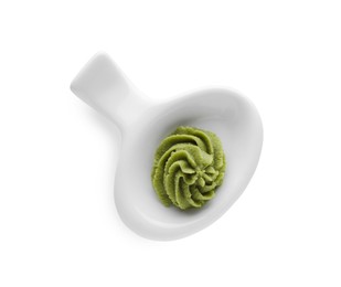 Photo of Plate with swirl of wasabi paste isolated on white, top view